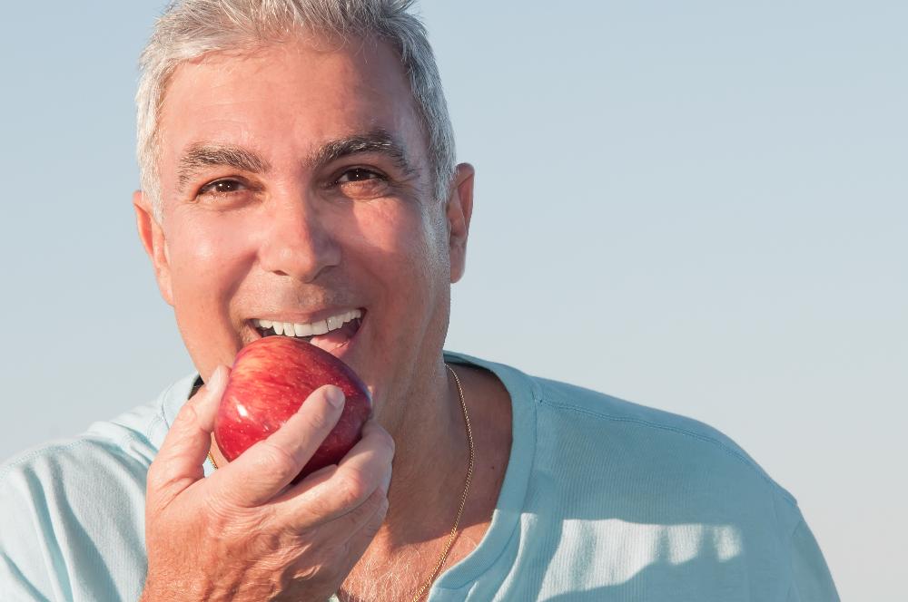 man enjoying an apple in east hills, nsw