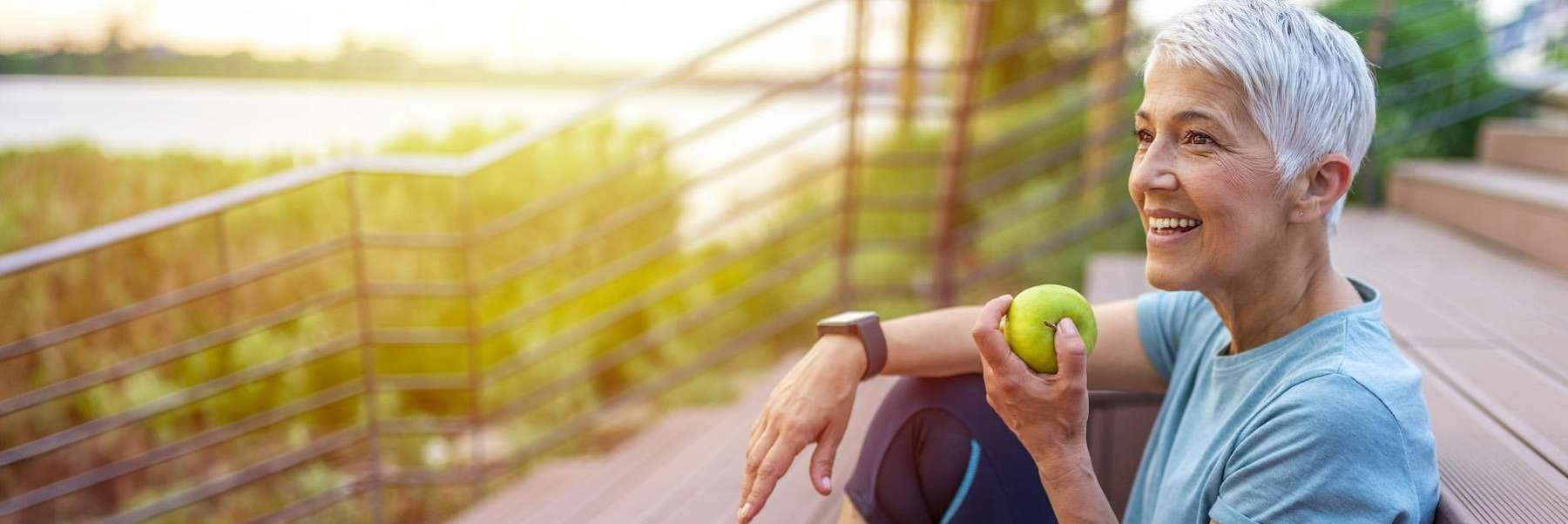 woman eating apple with her all on 4 dental implants in picnic point