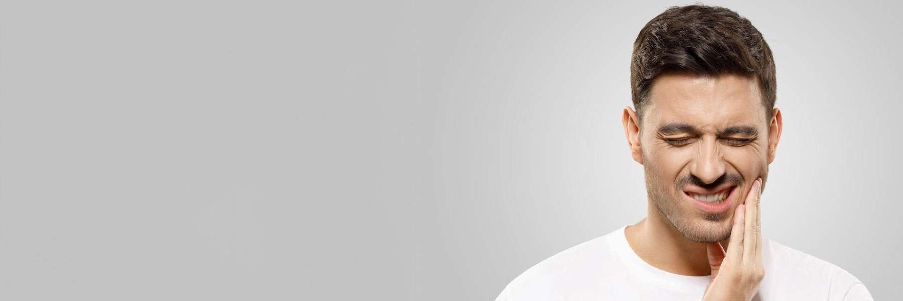 person with toothache before scheduling with emergency dentist oatley