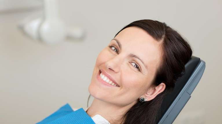 after-hours dentist east hills | woman at dentist
